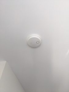 a smoke detector on a ceiling